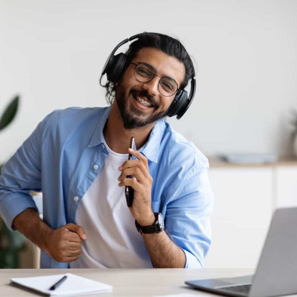 cheerful-arab-guy-in-wireless-headphones-listening-2021-04-14-21-04-02-utc-min.jpg