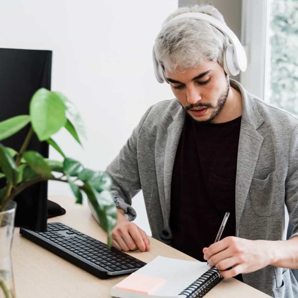 young-hipster-man-using-computer-and-headphones-wh-2021-06-01-05-57-15-utc-min.jpg